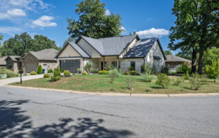 Front exterior of the brick home at 1341 Hampshire Circle in Mountain Home, Arkansas, with an attached garage and landscaped front yard.