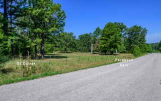Cleared and wooded acreage along Old Arkana Road near Mountain Home, Arkansas, with mature trees and labels for the southeast corner and proposed gate.
