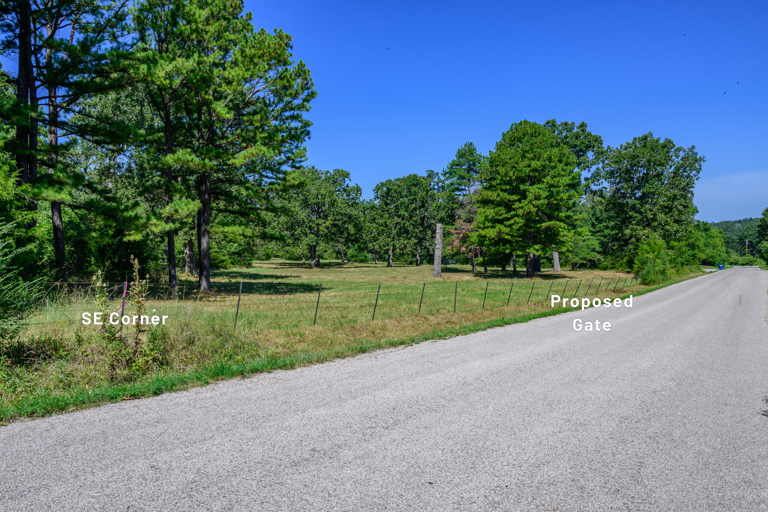 Cleared and wooded acreage along Old Arkana Road near Mountain Home, Arkansas, with mature trees and labels for the southeast corner and proposed gate.